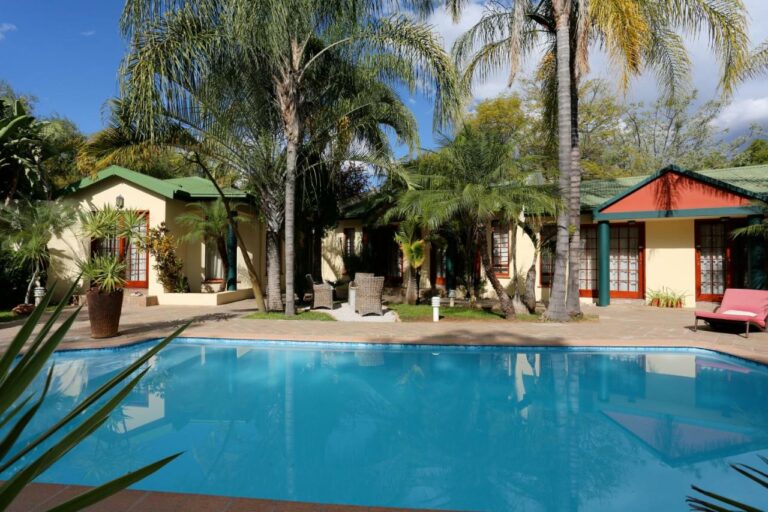 Veranda, guest rooms and palms in the courtyard of the Minen Hotel in Tsumeb
