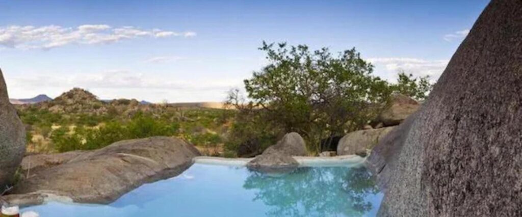 Rock pool at Hoada Camp Site surrounded by granite boulders, Damaraland, Namibia