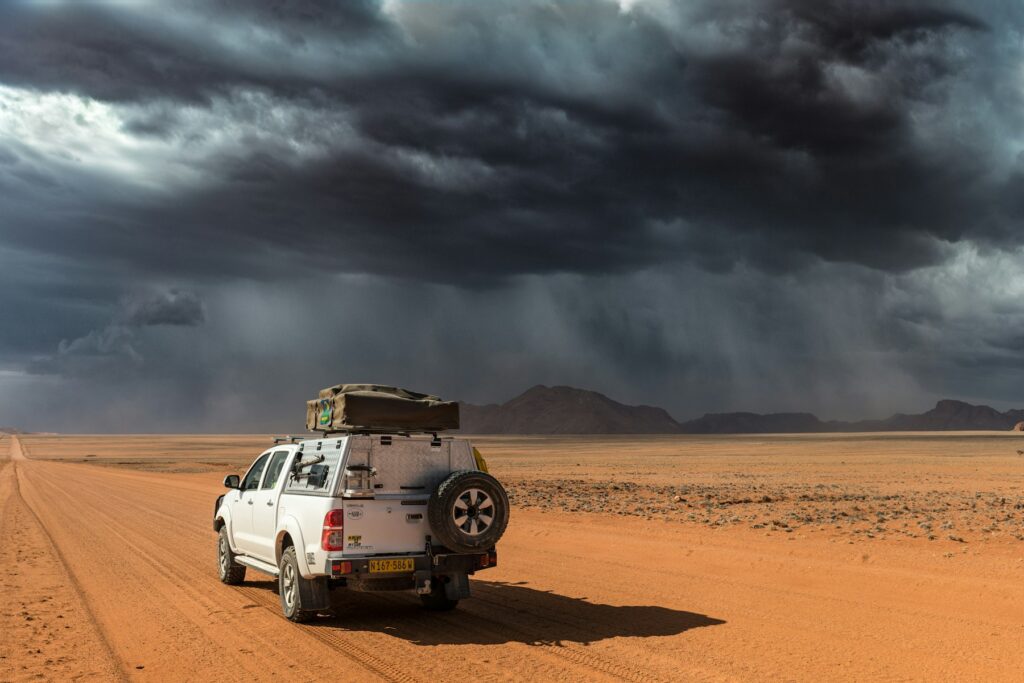 Vehicle on a northern Namibia road approaching King Nehale Gate