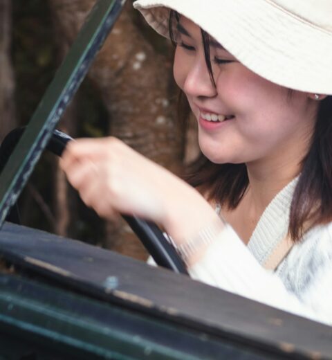 Traveller using sun protection in Etosha style safari vehicle