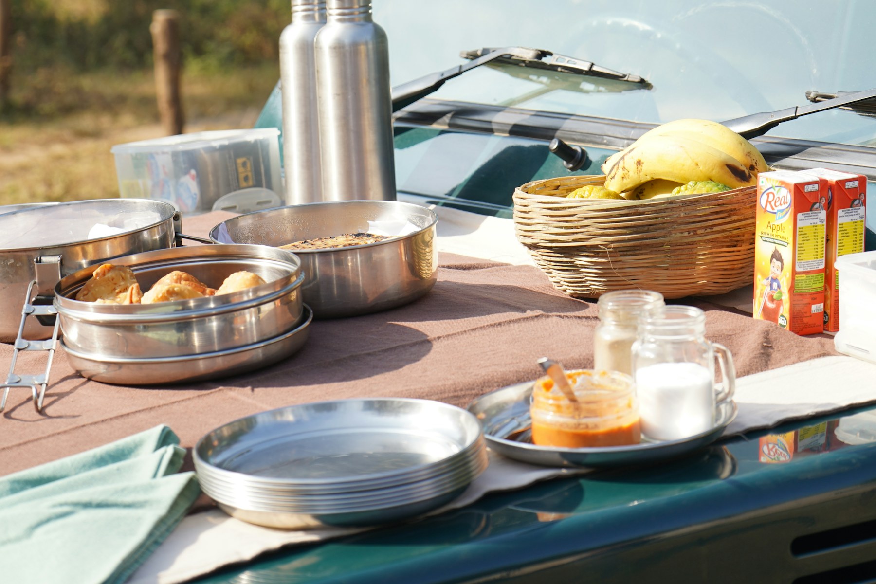 Simple early game drive breakfast arranged beside a safari vehicle